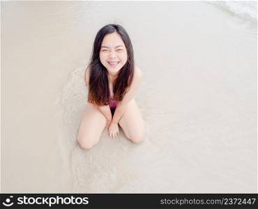 Portrait of happy Asian young woman on the beach
