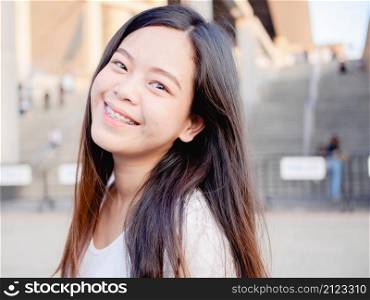 Portrait of happy Asian young woman outdoors