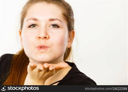 Portrait of happy attractive woman having long brown straight hair wearing black tshirt sending air kisses. Portrait of happy attractive woman sending air kiss