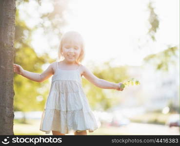 Portrait of happy baby girl in city park