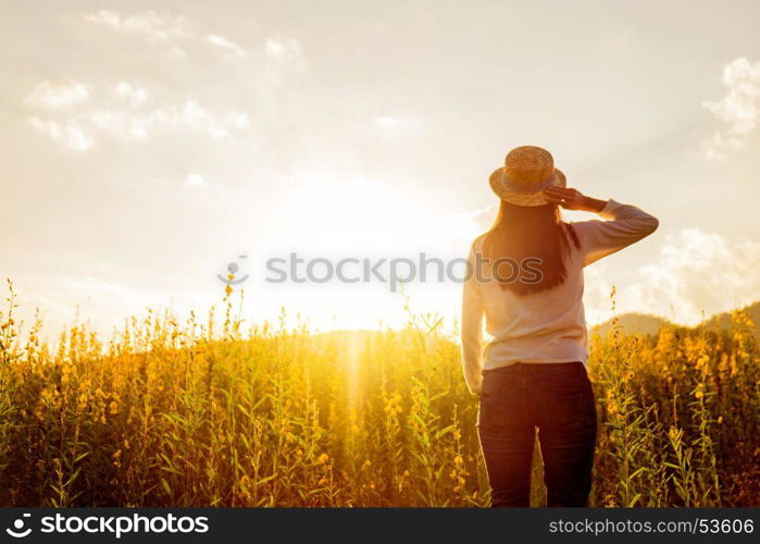 portrait of happy beautiful happy youngwoman relaxing in park. Joyful female model breathing fresh air outdoors and enjoying smell in a flower spring or summer garden, vintage tone.