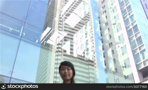 Portrait of happy beautiful Japanese female manager looking at camera. Young Asian businesswoman, confident girl, elegant woman smiling near office buildings. Career, success. Slow motion