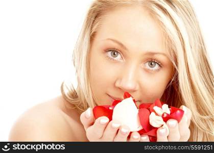 portrait of happy blond in spa with red and white rose petals