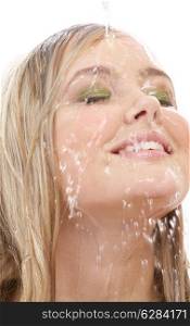 portrait of happy blond washing face in shower