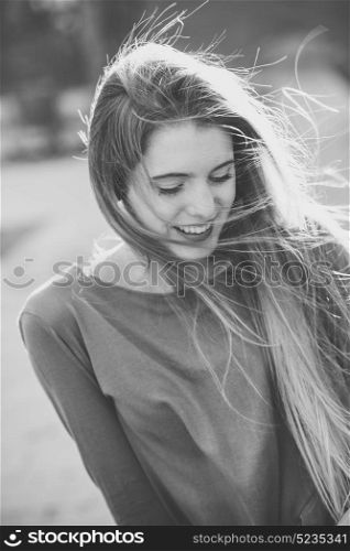 Portrait of happy blonde girl in urban background