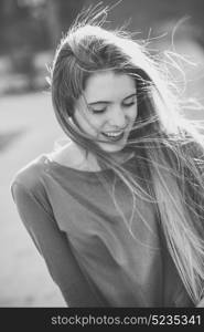 Portrait of happy blonde girl in urban background