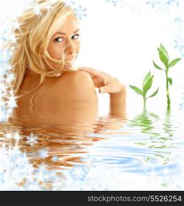 portrait of happy blonde in water with green plants