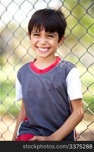 Portrait of happy boy laughing on a playground, outdoors