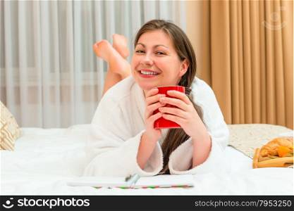 portrait of happy brunette on the bed