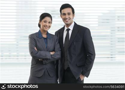 Portrait of happy business people standing together in office