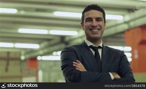 Portrait of happy businessman employed in logistics facility smiling at camera, people working in warehouse, workers in industry. 14of19