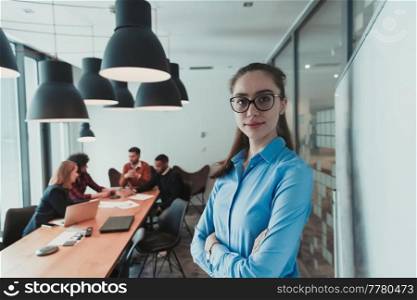Portrait of happy businesswoman owner in modern office. Businesswoman smiling and looking at camera. Busy diverse team working in the background. Leadership concept. Head shot. High-quality photo. Portrait of happy businesswoman owner in modern office. Businesswoman smiling and looking at camera. Busy diverse team working in background. Leadership concept. Head shot.
