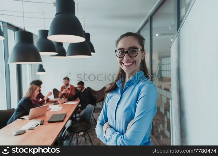 Portrait of happy businesswoman owner in modern office. Businesswoman smiling and looking at camera. Busy diverse team working in the background. Leadership concept. Head shot. High-quality photo. Portrait of happy businesswoman owner in modern office. Businesswoman smiling and looking at camera. Busy diverse team working in background. Leadership concept. Head shot.