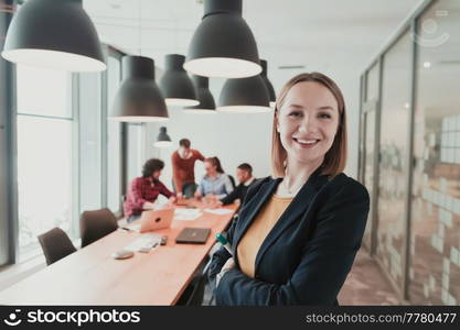 Portrait of happy businesswoman owner in modern office. Businesswoman smiling and looking at camera. Busy diverse team working in the background. Leadership concept. Head shot. High-quality photo. Portrait of happy businesswoman owner in modern office. Businesswoman smiling and looking at camera. Busy diverse team working in background. Leadership concept. Head shot.