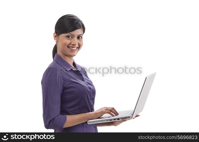 Portrait of happy businesswoman using laptop on white background