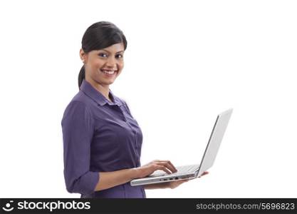 Portrait of happy businesswoman using laptop on white background