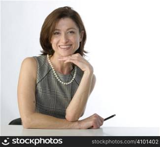 Portrait of happy businesswoman with a pen in hand