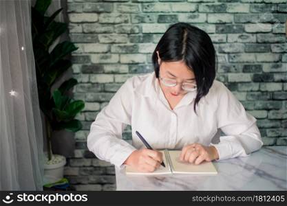 Portrait of happy businesswoman working at home with laptop on desk