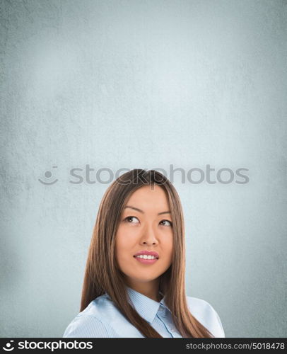 Portrait of happy Caucasian business woman standing over grunge background