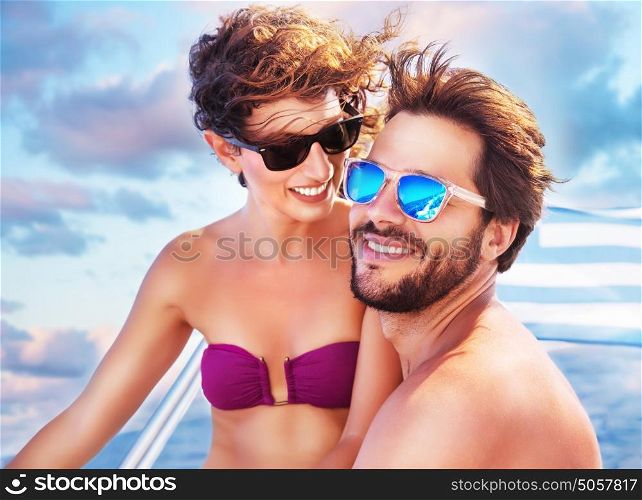 Portrait of happy cheerful cute couple having fun on sailboat, enjoying each other in romantic summer trip, spending honeymoon in the sea