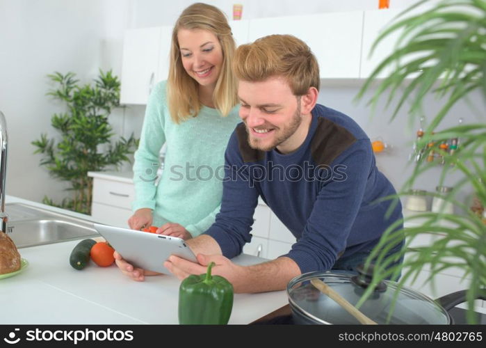 portrait of happy couple cooking together in the kitchen