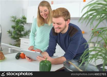 portrait of happy couple cooking together in the kitchen