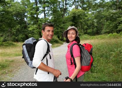 Portrait of happy couple hiking in countryside