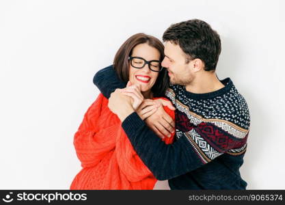 Portrait of happy couple in love embrace each other, have positive smiles, date and meet after not seeing long time, isolated over white background. People, romance and realtionship concept.