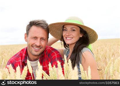 Portrait of happy couple in wheat field