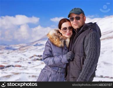 Portrait of happy couple spending winter vacation in the mountains, ski resort, cold weather, romantic relationship concept