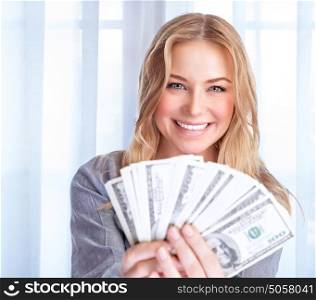 Portrait of happy excited woman holding in hands many dollars, at home, financial success, spending money, wealth concept