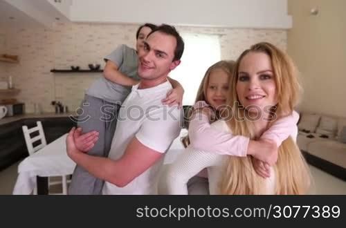 Portrait of happy family having fun with children at home
