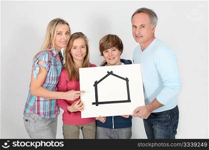 Portrait of happy family holding message board