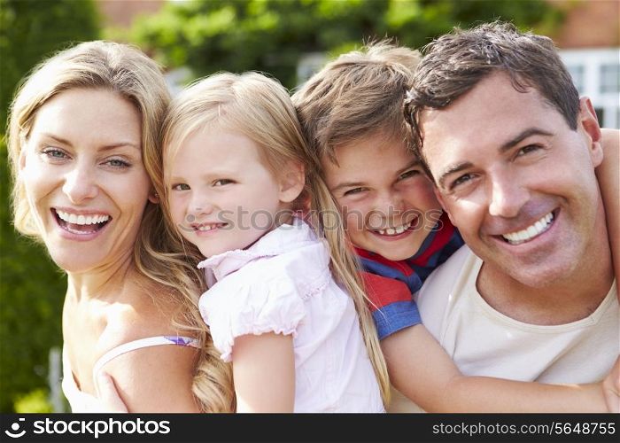 Portrait Of Happy Family In Garden