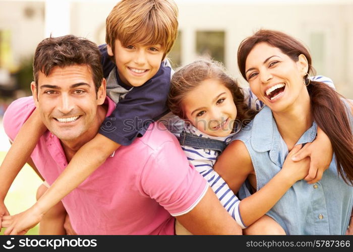 Portrait Of Happy Family In Garden At Home