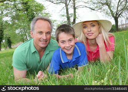 Portrait of happy family laying in grass