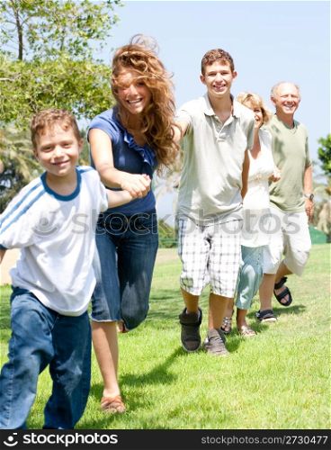 portrait of happy family making hand chain holding each other