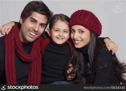 Portrait of happy family over grey background