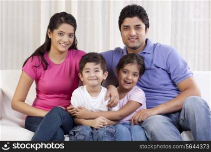 Portrait of happy family sitting on sofa
