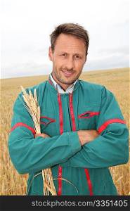 Portrait of happy farmer in wheat field