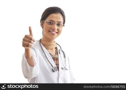 Portrait of happy female doctor showing thumbs up sign isolated over white background