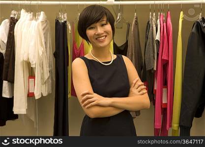 Portrait of happy Female fashion designer standing arms crossed