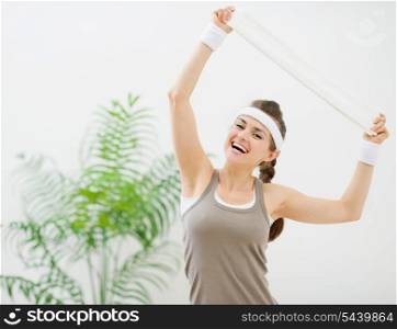 Portrait of happy fitness woman with towel