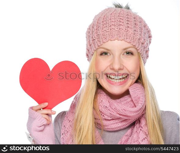 Portrait of happy girl in winter clothes showing heart shaped postcard