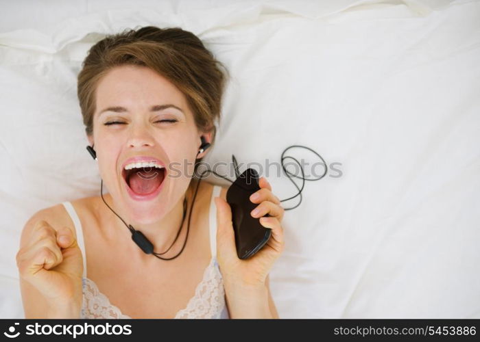 Portrait of happy girl listening music