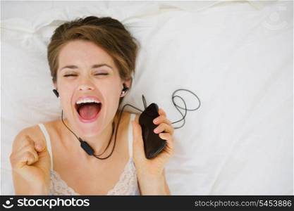 Portrait of happy girl listening music