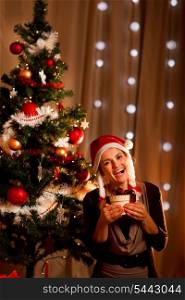 Portrait of happy girl near Christmas tree with present box&#xA;