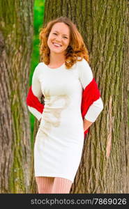 portrait of happy girl near old trees in the park