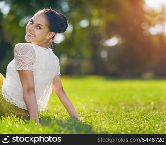 Portrait of happy girl sitting on meadow