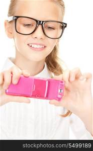 portrait of happy girl taking picture with cell phone